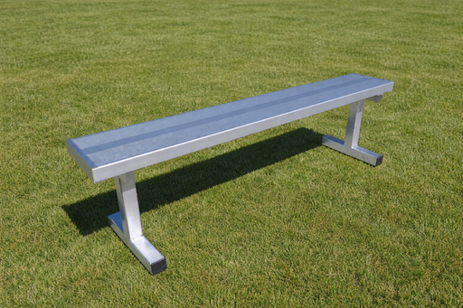 Long metal bench on a grassy field