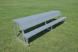 Gray bench on a grassy field
