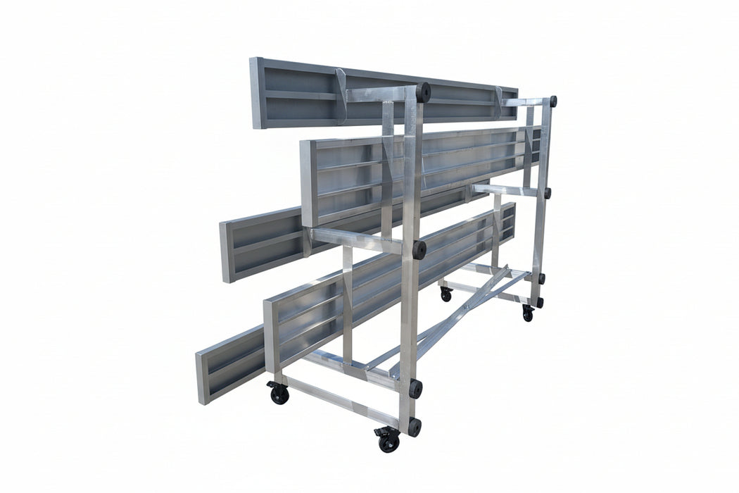Metal shelving unit on wheels in an outdoor industrial setting with a building in the background.