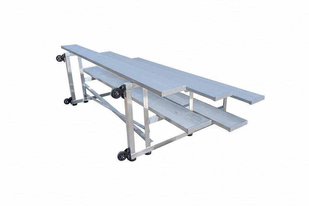 Metal workbench with wheels on a concrete surface, with a truck in the background.