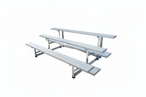 Metal picnic table on a concrete surface with a workshop in the background