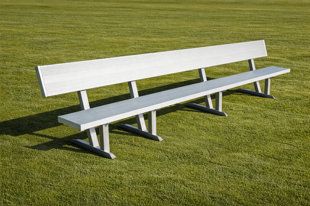 Long white bench on a grassy field