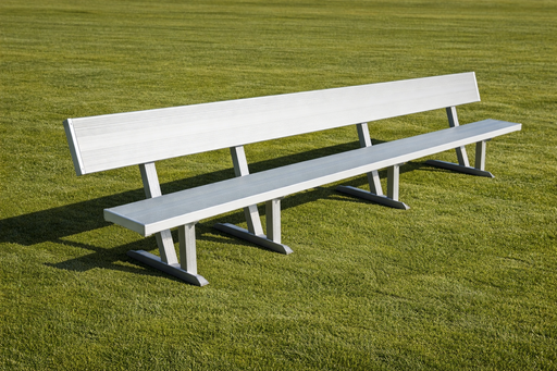 Long white bench on a grassy field