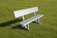 White bench on a grassy field